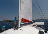 crew on deck of multihull sailing yacht